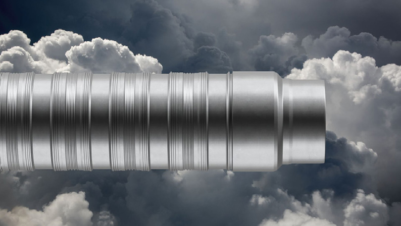 Close up of the Welltec Annular Barrier WAB tool showing its grooved metal design set against a backdrop of dramatic clouds.