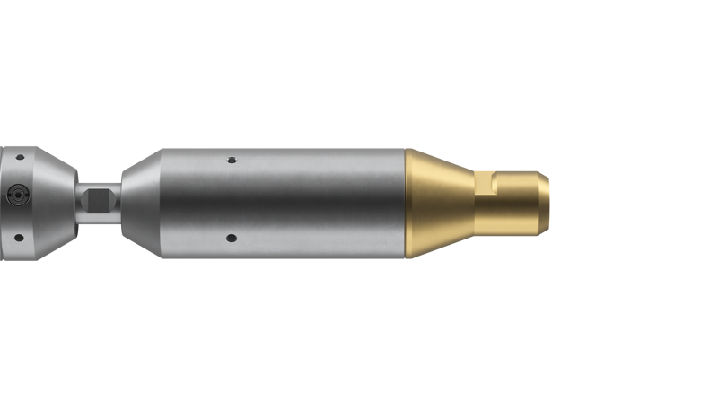 Side view of a Welltec tool featuring a metallic body with a gold-colored end piece, designed for precision downhole operations.