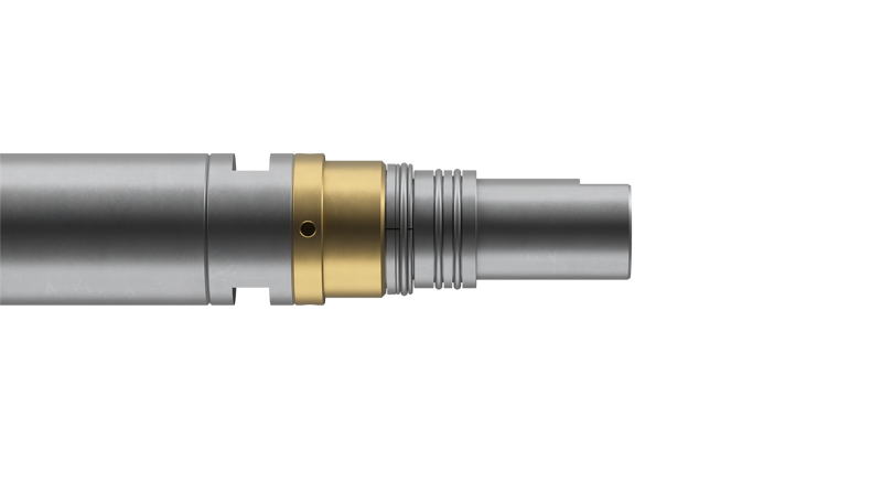 Close-up view of a Welltec tool with metallic body, gold-colored ring, and precise engineering for downhole operations.