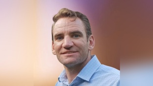 Close up picture of man in blue shirt